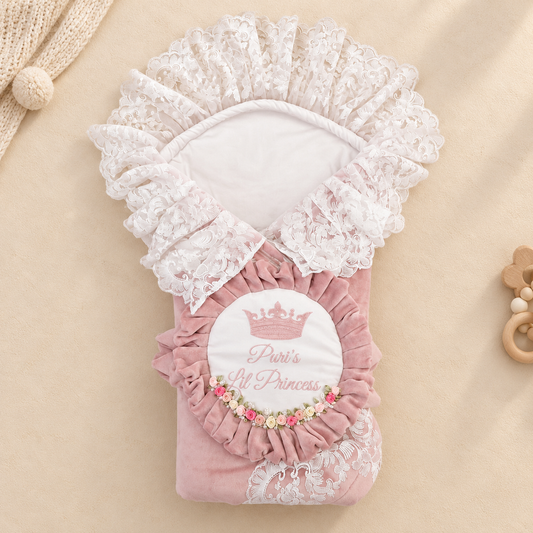 A pink velvet baby blanket or swaddle with white lace trim, featuring a central white patch with a pink crown and the words 'Princess' and 'Paris'.