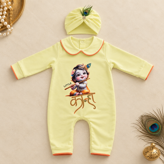 A pale yellow baby romper with a cartoon Krishna graphic and Devanagari text, shown with a matching yellow headband on a beige background with decorative props.